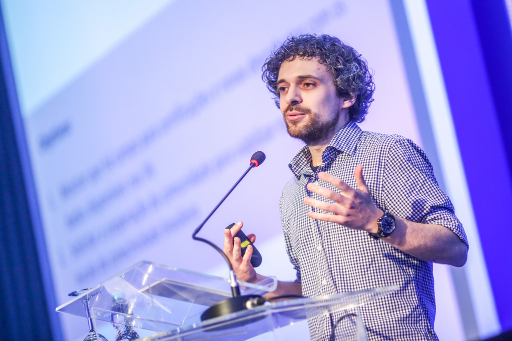 Dr. Müller speaking in a conference